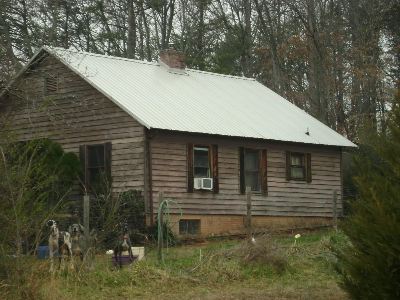 White metal roof on an old wood sided farmhouse, from a Metal Roof Installation job in Newton Falls